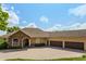 Inviting home boasts a paver driveway, three-car garage, stone accents, and well-maintained landscaping at 18008 Victorian Dr, Clermont, FL 34715