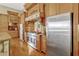 Well-equipped kitchen featuring a large stainless steel fridge, granite counters, and wood cabinetry at 18008 Victorian Dr, Clermont, FL 34715