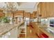 Open concept kitchen with granite countertops, custom cabinetry, and modern appliances under a decorative ceiling at 18008 Victorian Dr, Clermont, FL 34715