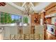 Gourmet kitchen island with bar seating, granite counters, custom cabinetry, and large windows offering scenic views at 18008 Victorian Dr, Clermont, FL 34715