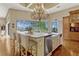 Bright kitchen boasts an island with bar seating and granite countertops, perfect for entertaining at 18008 Victorian Dr, Clermont, FL 34715