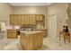 Spacious laundry room with an island, granite countertops, and built-in cabinetry at 18008 Victorian Dr, Clermont, FL 34715