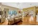 Spacious living room featuring an open floor plan, hardwood floors, and natural lighting at 18008 Victorian Dr, Clermont, FL 34715