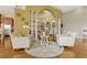 Elegant sitting area with decorative columns, patterned rug, and views into the dining and kitchen areas at 18008 Victorian Dr, Clermont, FL 34715