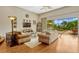 Bright living room with hardwood floors, comfortable seating, and a view of the outdoor pool area at 18008 Victorian Dr, Clermont, FL 34715