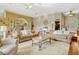 Expansive living room offers plush seating, a decorative fireplace, and an elegant design with arched doorways at 18008 Victorian Dr, Clermont, FL 34715