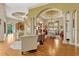 Open floor plan showcases the living area, dining room, and kitchen, with decorative columns and lighting at 18008 Victorian Dr, Clermont, FL 34715