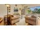 Cozy living room featuring two sofas, a large window and view of backyard pool and a decorative media center at 18008 Victorian Dr, Clermont, FL 34715
