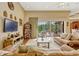 Inviting living room featuring large windows, comfortable seating, and access to an outdoor living space at 18008 Victorian Dr, Clermont, FL 34715