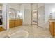 A view of the primary bath featuring a decorative vanity with adjacent access to the main bedroom at 18008 Victorian Dr, Clermont, FL 34715