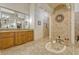 A view of the primary bath shows the soaking tub and beautifully tiled walk-in shower at 18008 Victorian Dr, Clermont, FL 34715