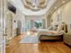 Inviting main bedroom features tray ceiling, sitting area, and private outdoor access at 18008 Victorian Dr, Clermont, FL 34715