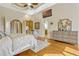 This stunning primary bedroom offers a ceiling fan and adjacent access to the ensuite bathroom at 18008 Victorian Dr, Clermont, FL 34715
