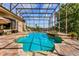 Stunning screened-in pool area with a spa and lush tropical landscaping at 18008 Victorian Dr, Clermont, FL 34715