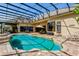Screened-in pool area featuring an umbrella covered seating area at 18008 Victorian Dr, Clermont, FL 34715