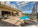 Large screened-in pool area with ample seating, dining area, and fire pit at 18008 Victorian Dr, Clermont, FL 34715