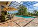 Relaxing outdoor space featuring a pool, a lounge area, and lush landscaping at 18008 Victorian Dr, Clermont, FL 34715