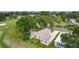 Expansive aerial view of home backing onto a golf course, surrounded by mature trees and landscaping at 1815 Kaufman Cir, Lady Lake, FL 32159