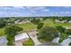 Scenic aerial view of a home nestled in a lush golf course community with beautiful green spaces at 1815 Kaufman Cir, Lady Lake, FL 32159