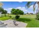Backyard patio with seating featuring a serene view of the golf course at 1815 Kaufman Cir, Lady Lake, FL 32159
