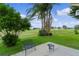 Backyard patio featuring a golf course view and mature trees, offering a peaceful setting at 1815 Kaufman Cir, Lady Lake, FL 32159
