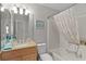 Bathroom features a combination tub and shower with a granite-topped vanity at 1815 Kaufman Cir, Lady Lake, FL 32159