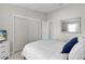 Bedroom with white walls, closet, and view of wall-mounted television at 1815 Kaufman Cir, Lady Lake, FL 32159