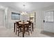 Charming dining area features tile floor, wood table, and stylish chandelier, creating a cozy space for meals at 1815 Kaufman Cir, Lady Lake, FL 32159