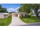 Charming single-story home with a well-manicured lawn and mature trees at 1815 Kaufman Cir, Lady Lake, FL 32159