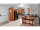 Well-equipped kitchen features wood cabinets, modern appliances, counter seating, and a door to the backyard at 1815 Kaufman Cir, Lady Lake, FL 32159