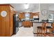 Spacious kitchen with wood cabinets, stainless steel appliances, breakfast bar seating, and lots of natural light at 1815 Kaufman Cir, Lady Lake, FL 32159