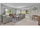 Comfortable living room featuring neutral tones, ample seating, large windows, and a bright and airy atmosphere at 1815 Kaufman Cir, Lady Lake, FL 32159