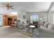 Open living space with a comfortable sitting area that connects to the kitchen with bar seating at 1815 Kaufman Cir, Lady Lake, FL 32159