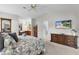 Main bedroom with en suite bathroom, dresser, and wall-mounted television at 1815 Kaufman Cir, Lady Lake, FL 32159