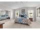 Comfortable main bedroom with a floral comforter, carpet, and mirrored closet at 1815 Kaufman Cir, Lady Lake, FL 32159