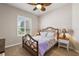Comfortable bedroom with light-colored walls, shuttered windows, ceiling fan, and stylish furniture at 1920 Iglesia St, The Villages, FL 32159