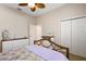 Bedroom featuring a stylish wooden bed frame, dresser, and double door closet for ample storage at 1920 Iglesia St, The Villages, FL 32159