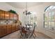 Cozy breakfast nook with natural light coming through large windows and decorative chandelier at 1920 Iglesia St, The Villages, FL 32159