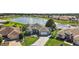 Aerial view of a single Gathering home situated on a large lot with mature trees near a lake at 1920 Iglesia St, The Villages, FL 32159
