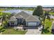Well-maintained single-Gathering home with a paver driveway, lush landscaping, and a two-car garage at 1920 Iglesia St, The Villages, FL 32159
