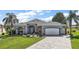 Charming single-Gathering home featuring a two-car garage, paver driveway, and manicured lawn at 1920 Iglesia St, The Villages, FL 32159