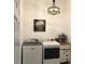 Clean laundry room with new appliances, tiled floors, and stylish decor for a modern look at 1920 Iglesia St, The Villages, FL 32159