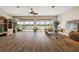 Spacious living room with wood flooring, natural light, and seamless access to the outdoors at 1920 Iglesia St, The Villages, FL 32159