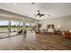 Bright living room features lovely furniture, stunning floor to ceiling windows, and lake views at 1920 Iglesia St, The Villages, FL 32159