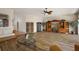 Well-lit living area with hardwood floors, tasteful furnishings, and access to kitchen at 1920 Iglesia St, The Villages, FL 32159