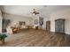 Open living space with modern flooring, wicker furniture, and an elegant iron wine rack at 1920 Iglesia St, The Villages, FL 32159