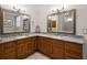 Bathroom featuring double sinks, granite countertops, and wood cabinets at 1920 Iglesia St, The Villages, FL 32159