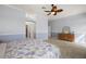 Tranquil bedroom featuring a ceiling fan, neutral paint, and a large window at 1920 Iglesia St, The Villages, FL 32159