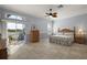 Bright main bedroom with a ceiling fan, patio access, and en-suite bath at 1920 Iglesia St, The Villages, FL 32159