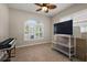 Multi-purpose room featuring a large shuttered window, tile flooring, and ceiling fan at 1920 Iglesia St, The Villages, FL 32159